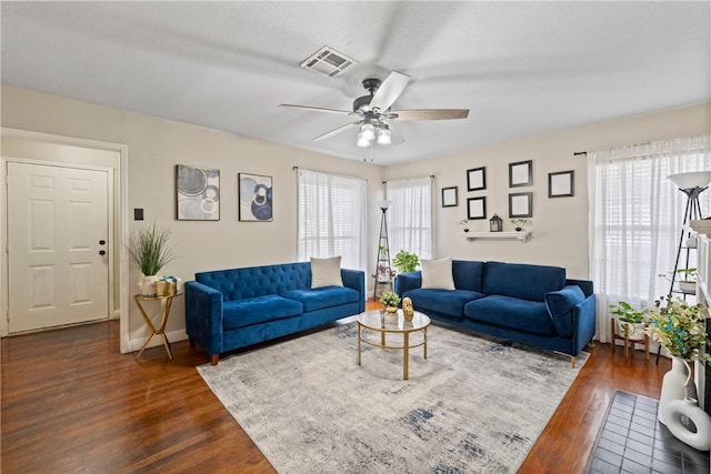 living room featuring ceiling fan, a healthy amount of sunlight, and dark hardwood / wood-style flooring