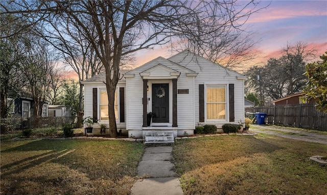 bungalow-style house featuring a lawn