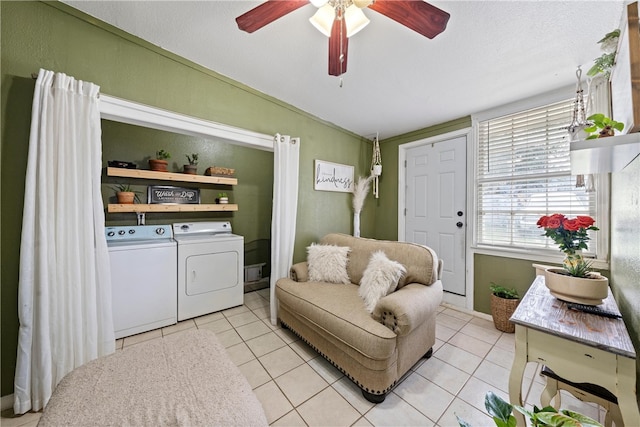 tiled living room with ceiling fan, lofted ceiling, and washing machine and dryer