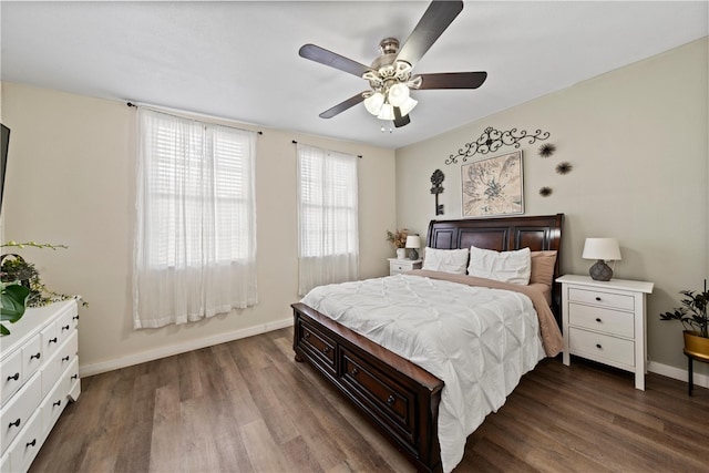 bedroom with ceiling fan and dark hardwood / wood-style flooring