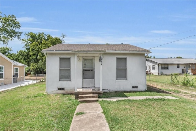 bungalow with a front yard