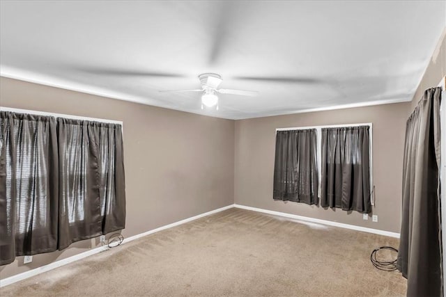 carpeted empty room featuring ceiling fan