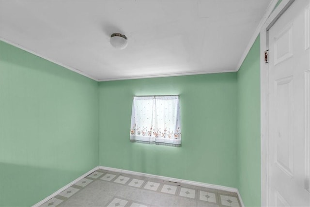 spare room featuring crown molding