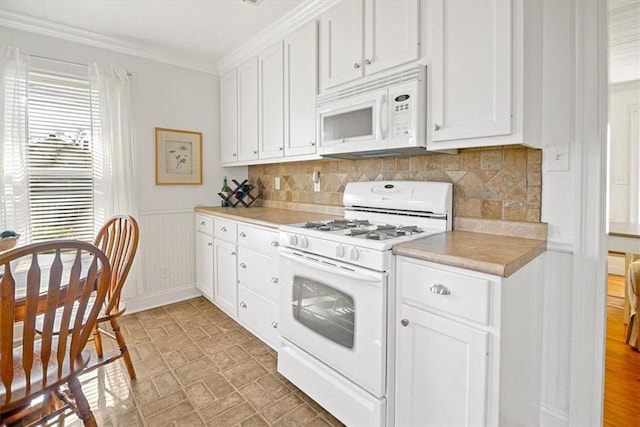 kitchen featuring white cabinets, white appliances, and ornamental molding