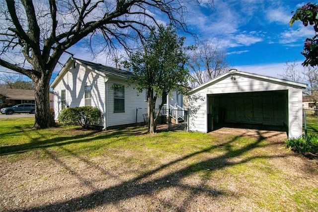 exterior space featuring a front lawn, an outdoor structure, and a garage