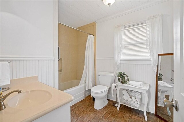 full bathroom with toilet, vanity, ornamental molding, and shower / bathtub combination with curtain