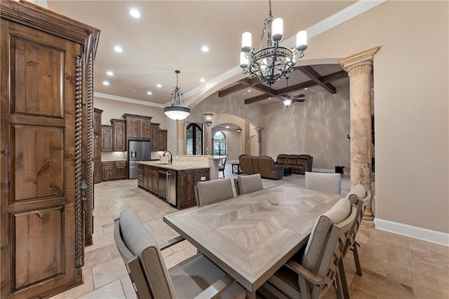 dining area with beamed ceiling, ornate columns, ornamental molding, and an inviting chandelier