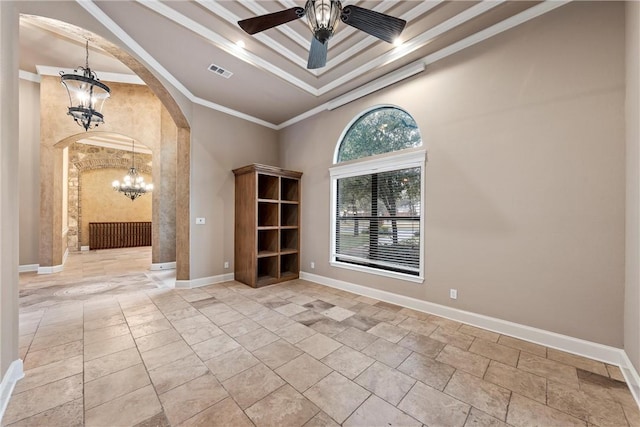 empty room featuring a high ceiling, ceiling fan with notable chandelier, and ornamental molding