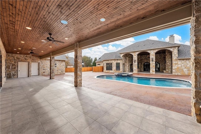 view of swimming pool with an in ground hot tub, ceiling fan, and a patio area