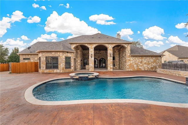 view of pool with a patio area and an in ground hot tub