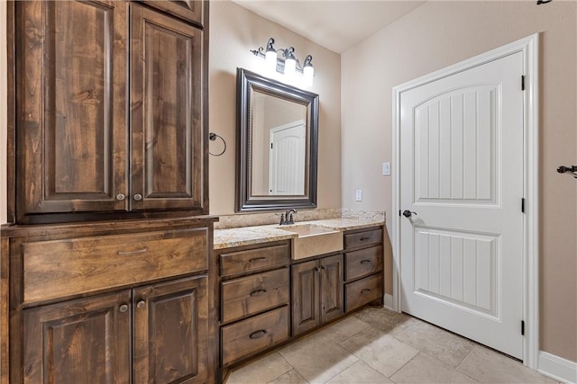 bathroom featuring tile patterned flooring and vanity