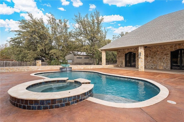 view of pool featuring an in ground hot tub, pool water feature, and a patio area