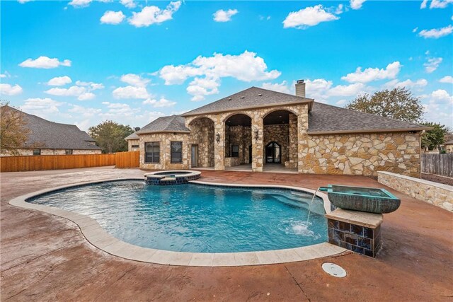 view of swimming pool featuring an in ground hot tub, pool water feature, and a patio area