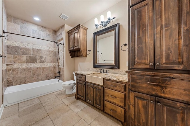 full bathroom featuring vanity, toilet, and tiled shower / bath