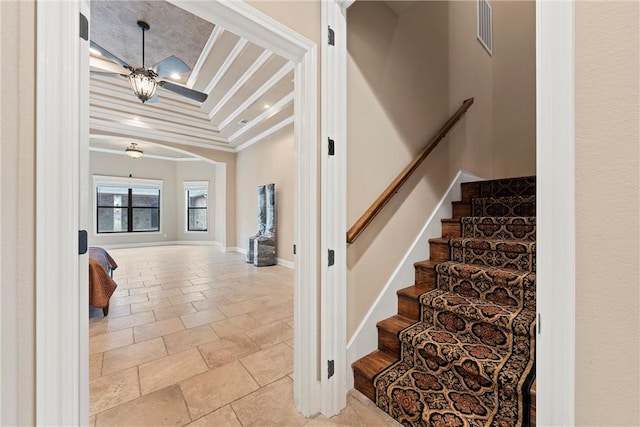 staircase featuring crown molding and a notable chandelier