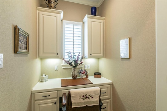 office featuring built in desk and crown molding