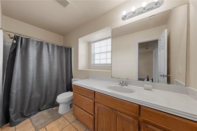 bathroom featuring a shower with shower curtain, a textured ceiling, vanity, tile patterned flooring, and toilet