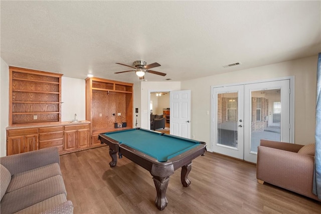 playroom with ceiling fan, french doors, light hardwood / wood-style floors, and billiards