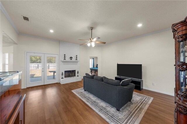 living room featuring ceiling fan with notable chandelier, light hardwood / wood-style floors, and sink