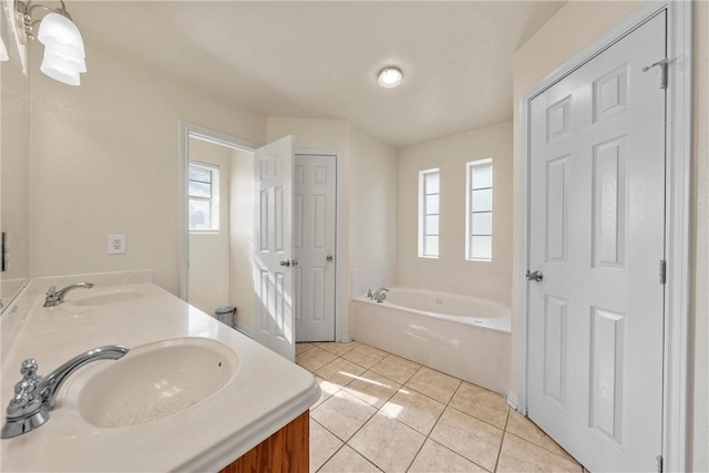 bathroom with vanity, tile patterned floors, and a tub