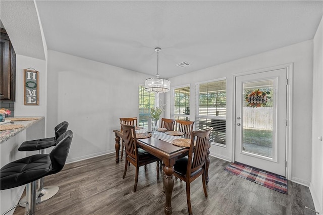 dining area with dark hardwood / wood-style flooring