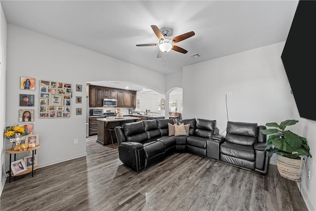 living room with ceiling fan, dark hardwood / wood-style flooring, and sink