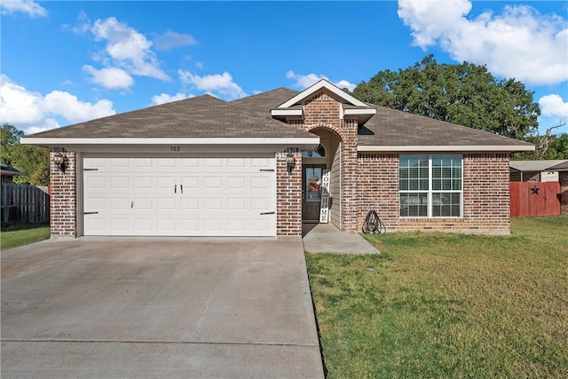 ranch-style house featuring a front lawn and a garage