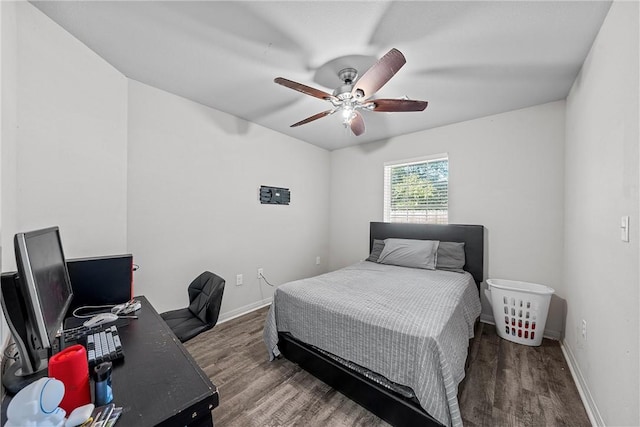 bedroom with ceiling fan and dark wood-type flooring