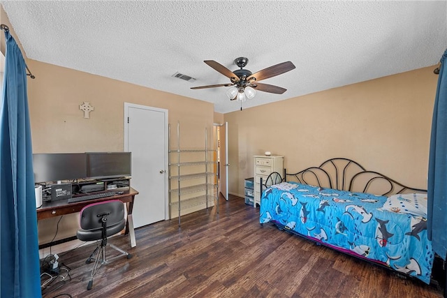 bedroom featuring ceiling fan, dark wood-type flooring, and a textured ceiling