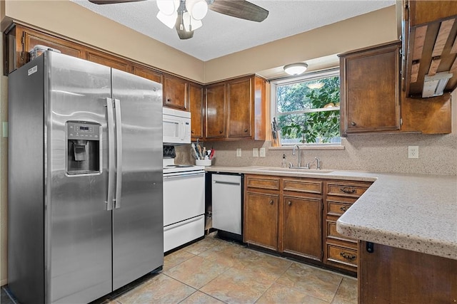 kitchen with ceiling fan, decorative backsplash, sink, and appliances with stainless steel finishes