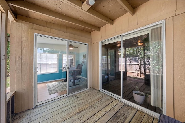 entryway featuring wood walls, beamed ceiling, and hardwood / wood-style flooring