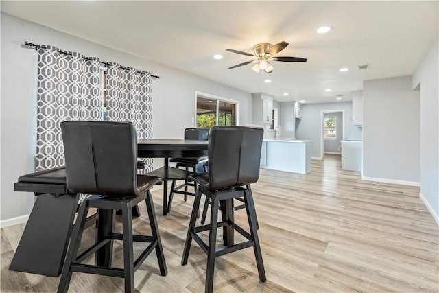 dining area featuring light wood-type flooring and ceiling fan