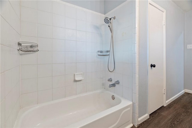 bathroom featuring tiled shower / bath combo and wood-type flooring