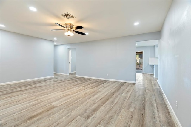 empty room featuring ceiling fan and light wood-type flooring