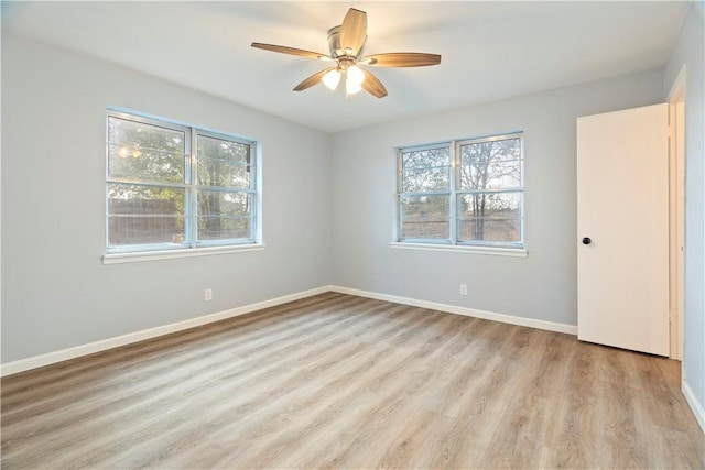 unfurnished room with light hardwood / wood-style flooring, a wealth of natural light, and ceiling fan