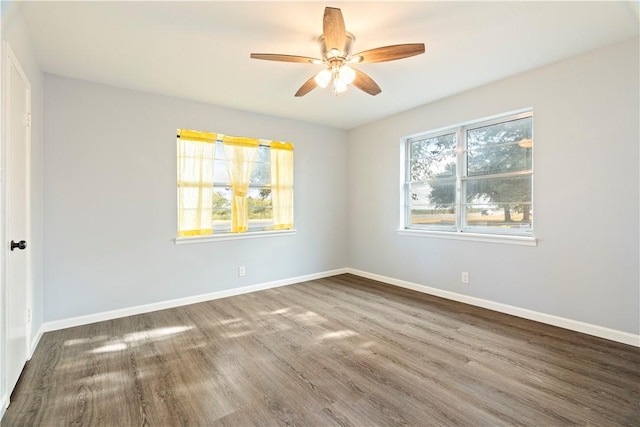 unfurnished room with ceiling fan and dark hardwood / wood-style flooring