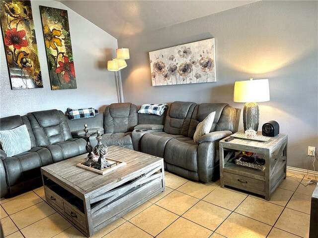 living room featuring light tile patterned floors and baseboards