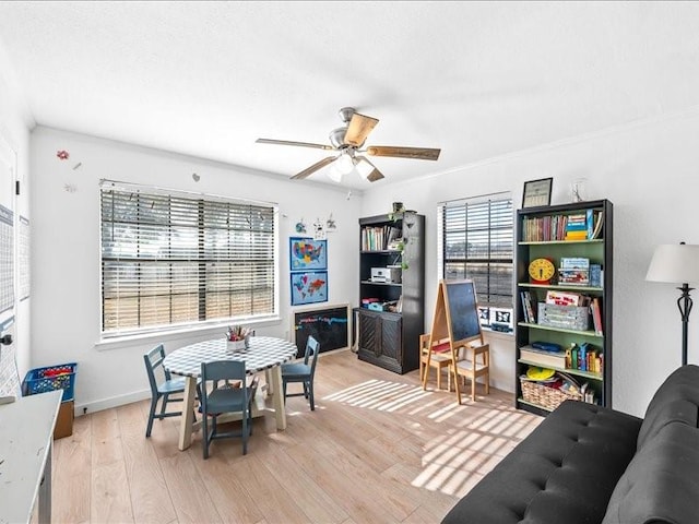 dining area with ceiling fan and light wood-type flooring