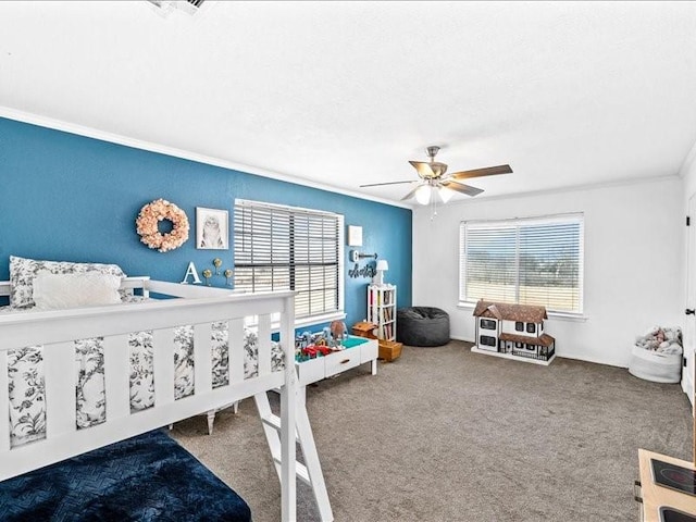 carpeted bedroom with multiple windows, ornamental molding, and ceiling fan