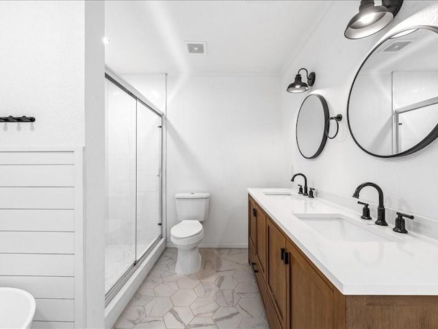 bathroom with toilet, vanity, and walk in shower