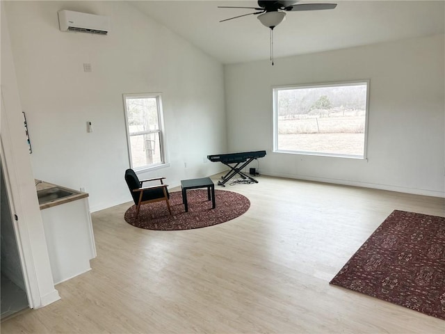 living area featuring ceiling fan, high vaulted ceiling, light hardwood / wood-style floors, and an AC wall unit