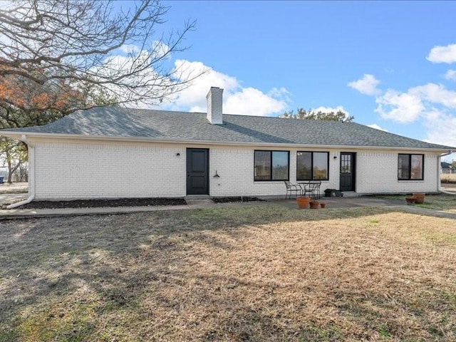 back of house with a lawn