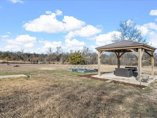 view of yard featuring a gazebo, a patio area, and a rural view