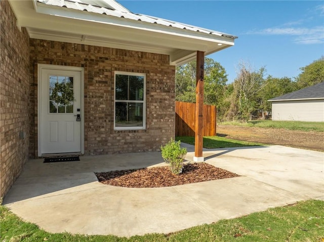 entrance to property featuring a patio area