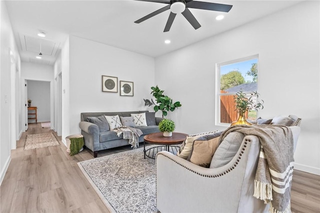 living room with ceiling fan and light hardwood / wood-style floors