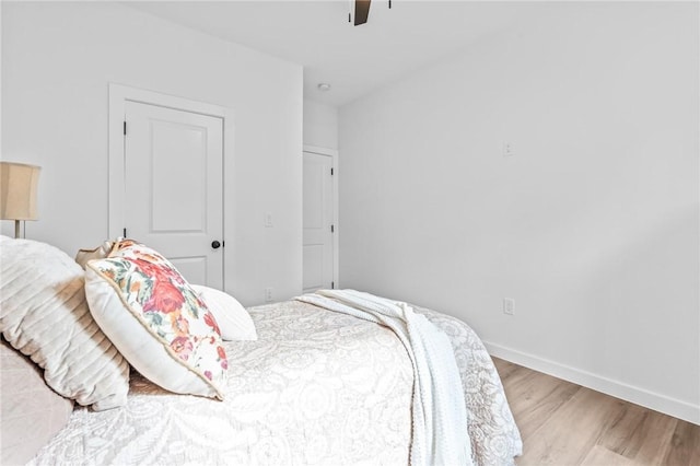 bedroom with ceiling fan and hardwood / wood-style flooring