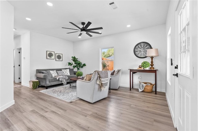 living room featuring ceiling fan and light wood-type flooring