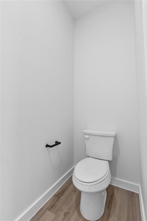 bathroom with hardwood / wood-style floors and toilet