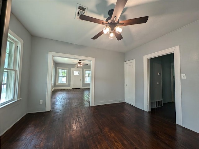 spare room with ceiling fan and dark hardwood / wood-style flooring