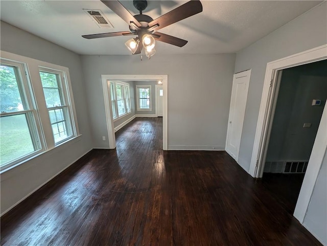 empty room featuring ceiling fan and dark hardwood / wood-style floors